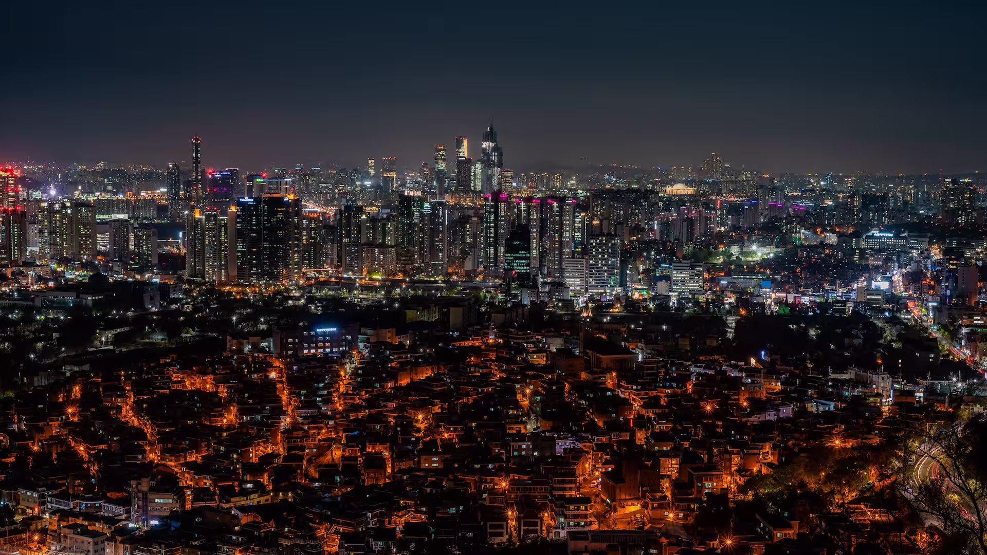 Korea Stunning night view of Seoul's illuminated skyscrapers and bustling cityscape from above